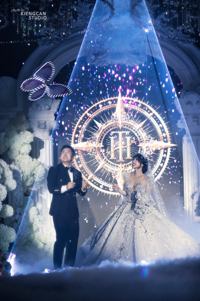 A butterfly carrying the wedding rings flies toward the couple.